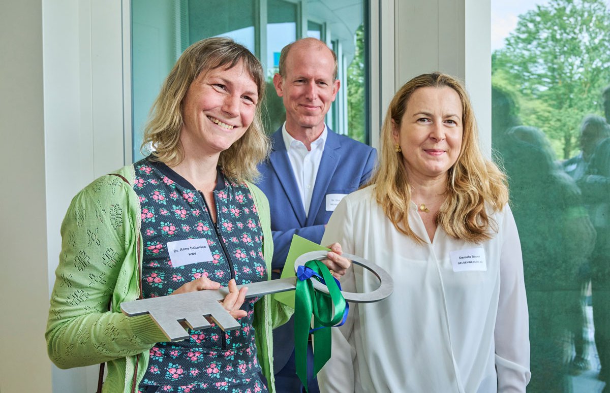 Dr. Anne Soltwisch bekommt als WWU-Geschäftsführerin symbolisch den Schlüssel für das H2O-Gebäude überreicht. Die WWU ist Mieterin in dem neusten Haus im Gelsenwasser-Quartier.
